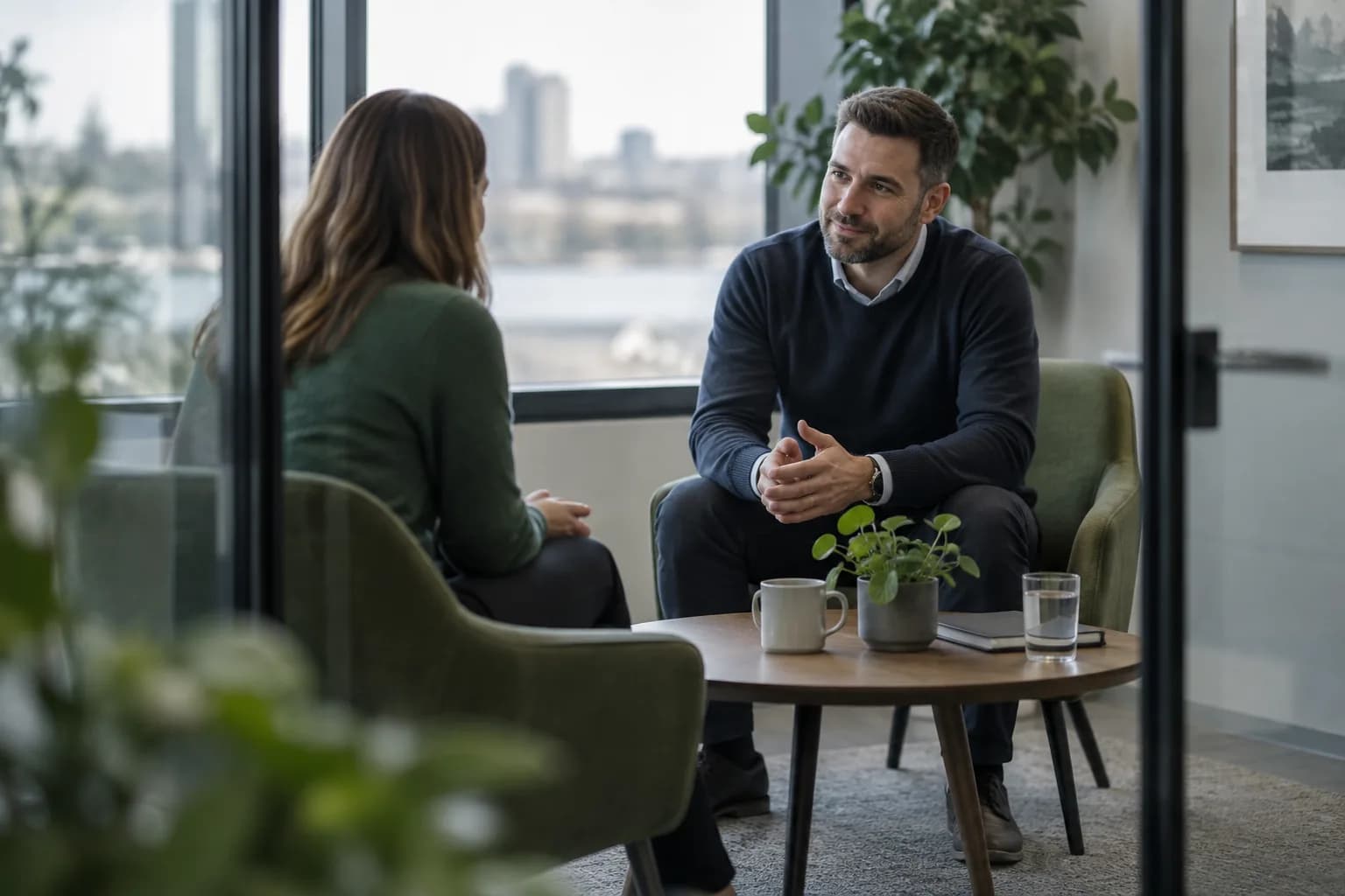 Two colleagues in a calm one-to-one conversation in a meeting room
