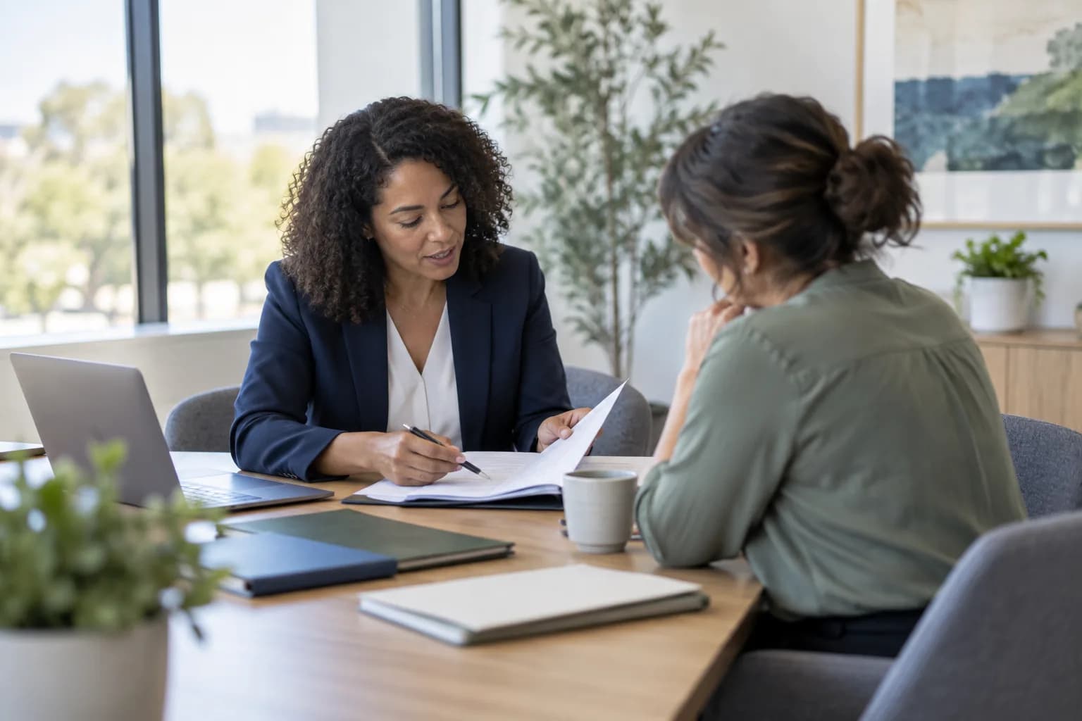 An HR consultant walking a business owner through documents