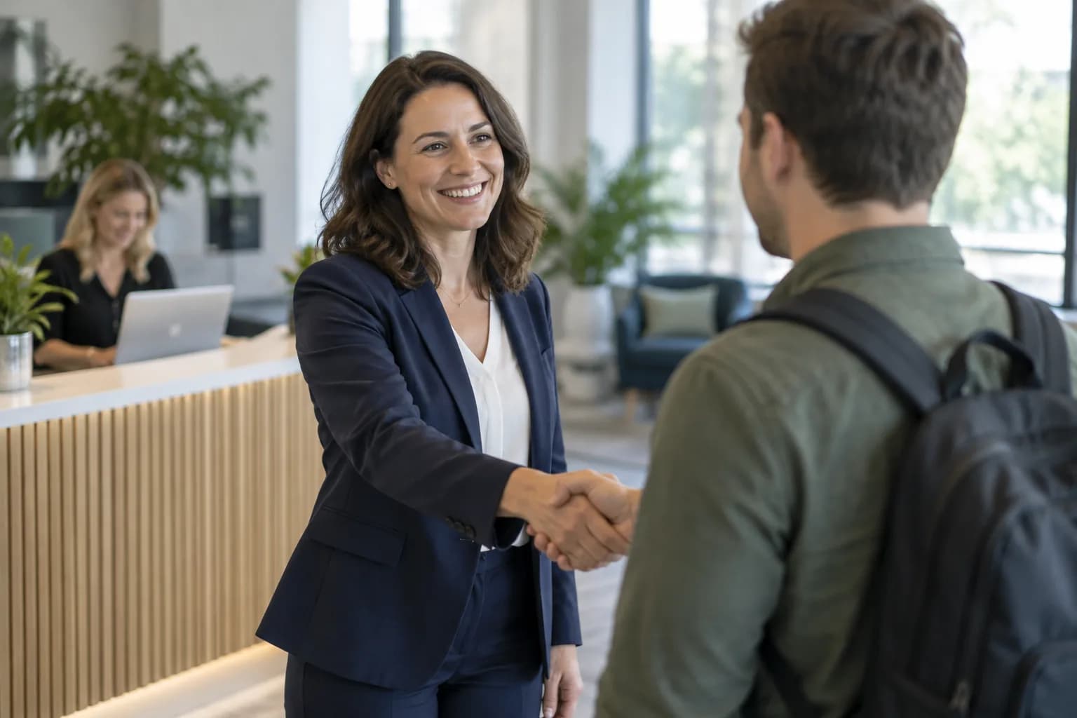 A hiring manager welcoming a new starter in an office reception